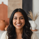 Portrait of a smiling South Asian woman in her late 20s, looking happy and trustworthy.